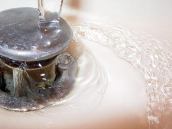 Macro image of a bathroom sink drain after a successful drain cleaning in Miami Beach, FL